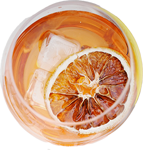 Orange-colored cocktail with orange slice and ice